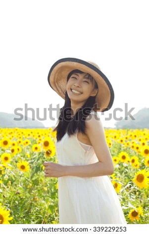 beautiful young woman in sunflower field
