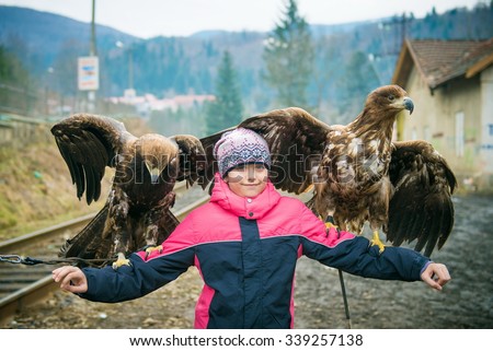 girl and an eagle, girl holding a large bird, girl with the eagles,  man and the falcon, birds of prey in the hands of a girl