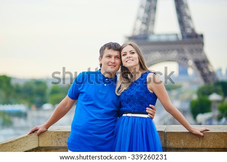 Romantic dating couple on Trocadero viewpoint in Paris, hugging, Eiffel tower is in the background