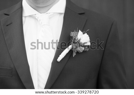 groom on his wedding day - with small rose in his jacket, black and white picture 