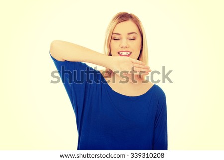 Happy young woman showing her palm.