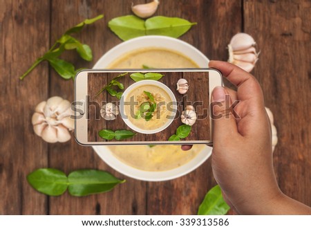 Image of shooting photographs with smartphone on asia food