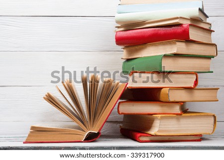 Open book, hardback books on wooden table. Back to school. Copy space for text