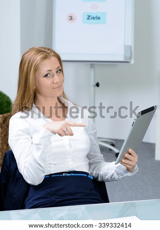 attractive businesswoman at office with tablet