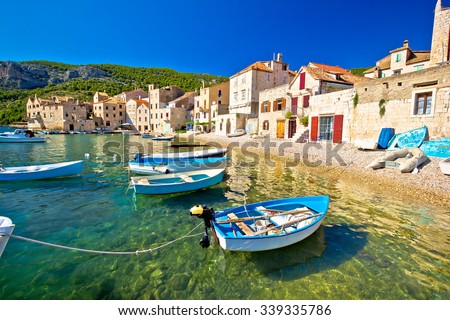 Scenic beach in Komiza village waterfront, Island of Vis, Croatia Royalty-Free Stock Photo #339335786