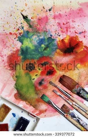 Mix of multicolored watercolors and paintbrushes 