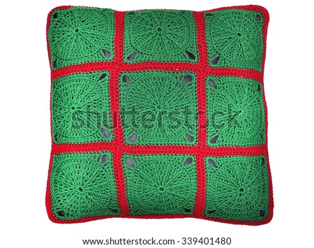 The pillow is knitted from squares, isolated on white background