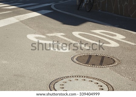 A road sign STOP written on asphalt