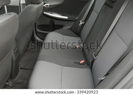 Car interior with back seats, sunlight flaring through Royalty-Free Stock Photo #339420923