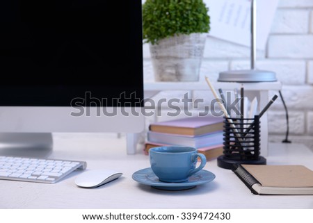 Workplace with computer and laptop on the table, close up