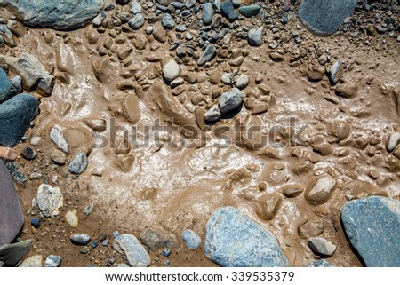 Close view on the muddy stones in the river