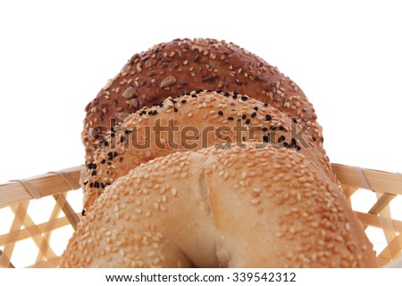 three different bagels in basket isolated over white background
