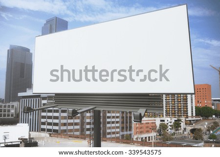 Blank white billboard on a background of buildings, mock up