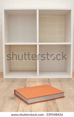 A studio photo of a simple white bookcase