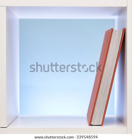 A studio photo of a simple white bookcase
