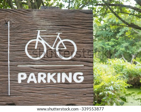 Wooden bicycle sign in the park.