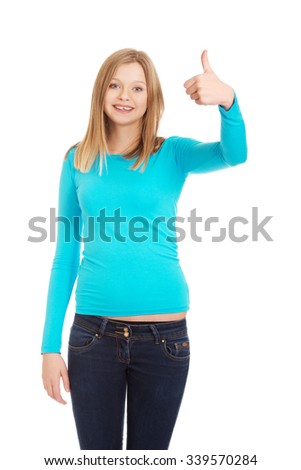 Happy young teenager showing thumbs up