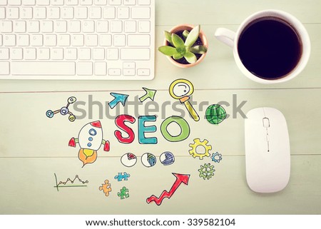  SEO concept with workstation on a light green wooden desk