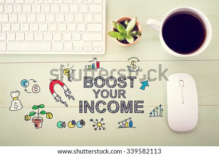 Boost Your Income concept with workstation on a light green wooden desk