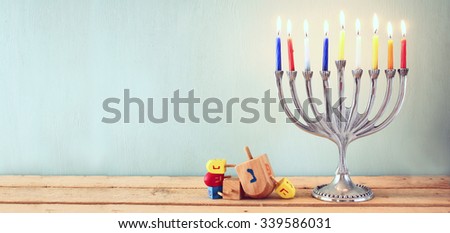 website banner image of of jewish holiday Hanukkah with menorah (traditional Candelabra). retro filtered