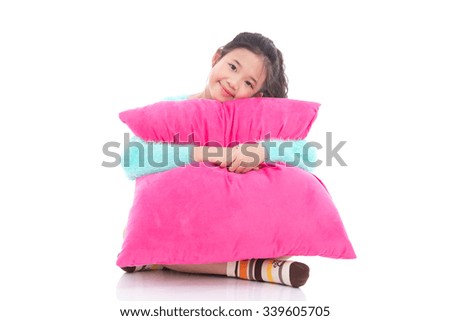 Beautiful asian girl with a big pink pillow on white background isolated