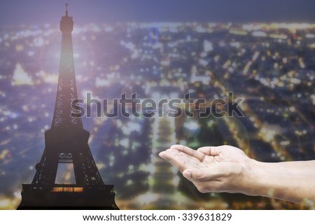 Empty female open human hands prayer with abstract Background top view of Paris in lights and bokeh. Concept for pray for Paris, Thanksgiving, Christmas, Forgiveness euro 2016 France.

