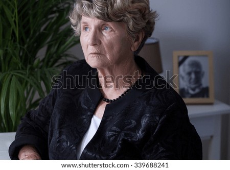 Close-up of a thoughtful elderly widow at home