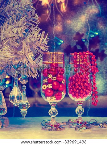 glasses of champagne, Christmas tree, Christmas decorations on a background of a winter window. holiday photo in old style of the image. stylized graphics, vintage, retro, maps, wallpaper
