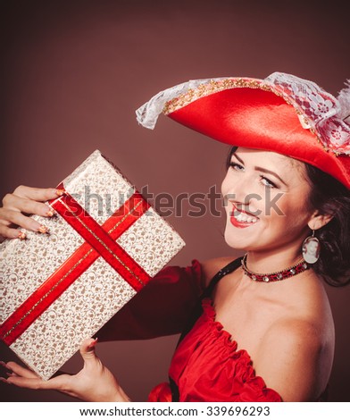 woman with gift box in masquerade costume