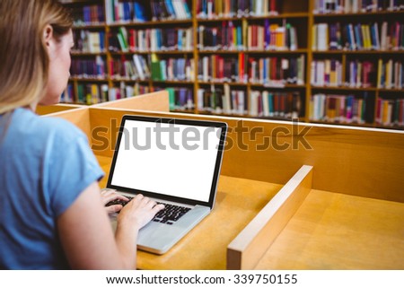 Mature student in the library using laptop at the university