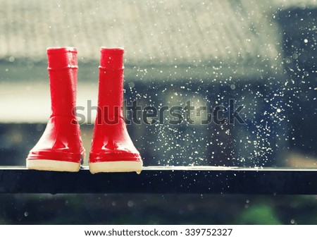Photo of red boots under rain