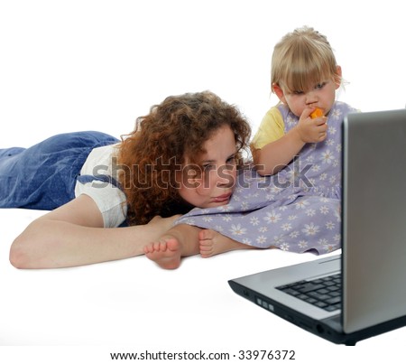 young woman with little girl looking at laptop