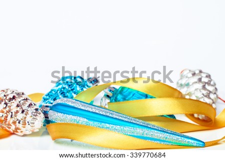 Christmas holiday decoration. Blue and gold ornament bauble with ribbon background. Festive merry xmas, new year celebration. Golden shiny light decorative closeup ball. 