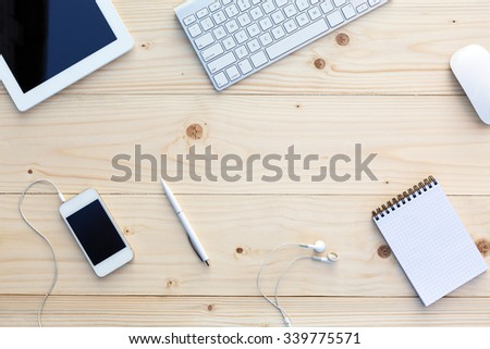 Light wooden Background and modern Business Items on Desk Office Computer Keyboard and Mouse White Pen Tablet PC opened Notepad Earphones dynamic Diagonal alignment 