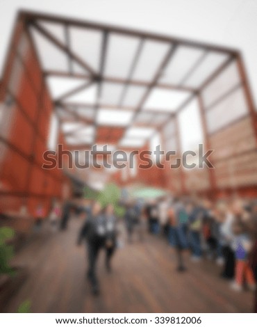 People crowd at the entrance of trade show, generic background. Intentionally blurred post production.