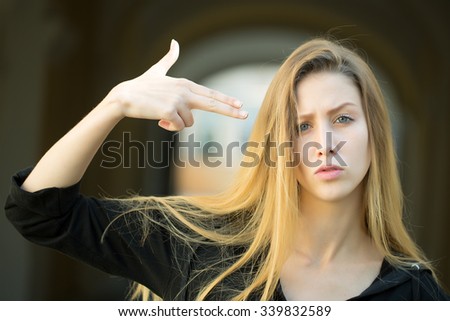 Closeup portrait of one beautiful serious cool blonde young woman with long hair outdoor looking forward on blurred background, horizontal picture