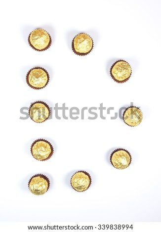 d,D,set of letter made by arrange gold chocolate warped on white background,isolated.