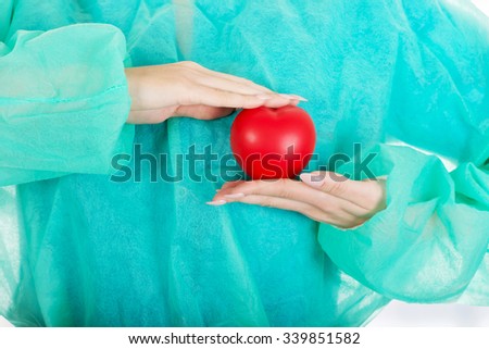 Smiling female surgeon doctor with heart.