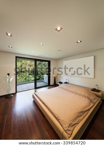 Interior of modern house, bedroom with balcony