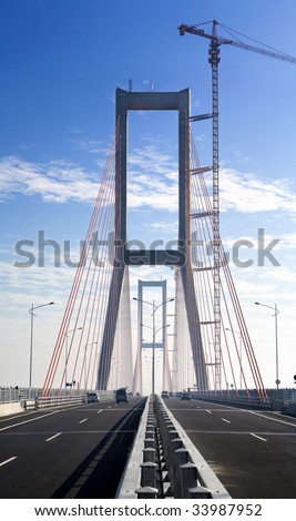 Vertical shot of new bridge in finishing stage. The area still covered by mist at early morning. The new landmark in the city that connecting two island, Suramadu Bridge. ***Stitched image***