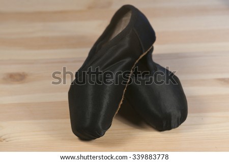Pointe shoes on a wooden background