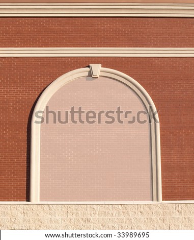 Ornate Roman styled brick wall with curved molding and a reduced opacity brick copy space.