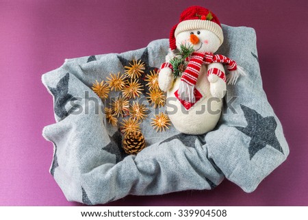 Happy snowman in a box with Christmas toys