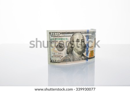 Banknote hundred dollars on the mirror surface