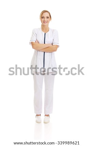 Young female doctor or nurse with folded arms.