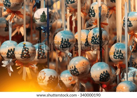 Closeup view of red and white baubles toy with paintings hanging with blurred background, horizontal picture