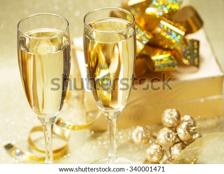 Two champagne glasses with gift boxes