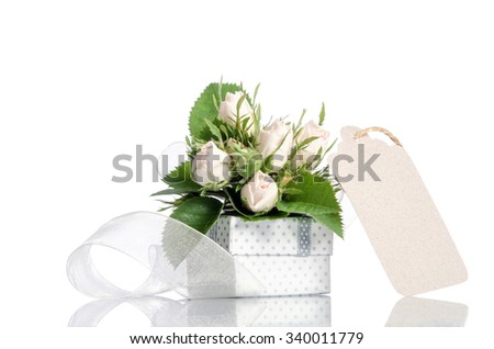 gift box and white roses with empty tag for you text on white background