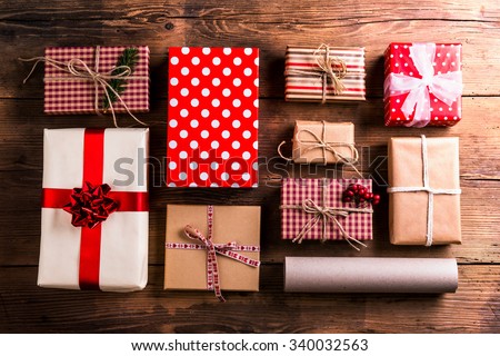 Christmas presents laid on a wooden table background Royalty-Free Stock Photo #340032563