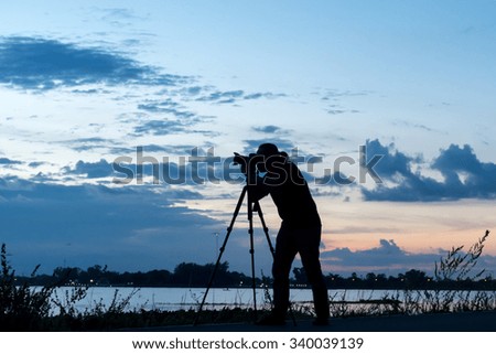 Silhouette of photographer during sunset